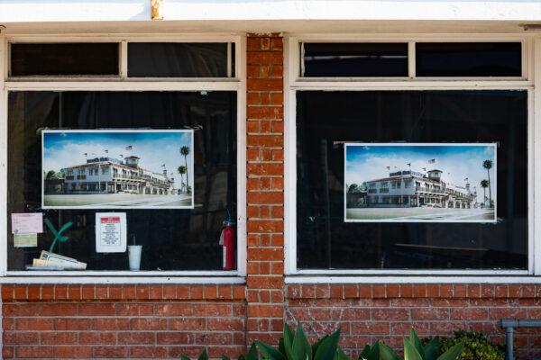An artist's rendition of how the remodeled Coast Inn will look are posted in the windows of the hotel in Laguna Beach, Calif., on Oct. 15, 2020 (John Fredricks/The Epoch Times)