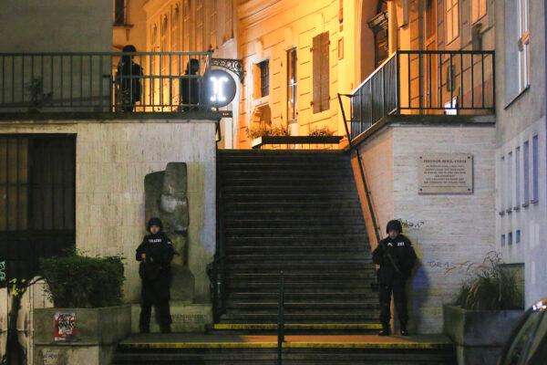 Police officers stay in position at stairs named "Theodor Herzl Stiege" near a synagogue after gunshots were heard, in Vienna on Nov. 2, 2020. (Ronald Zak/AP Photo)
