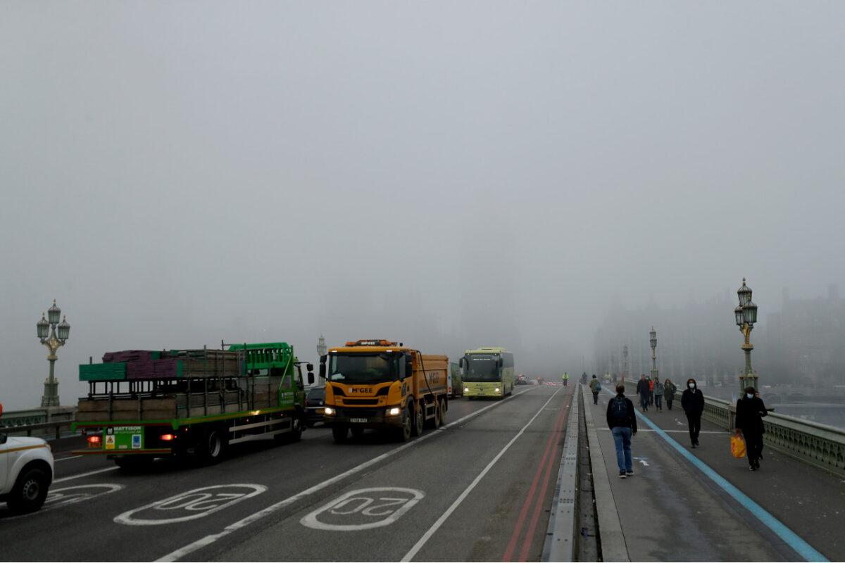 Traffic and people pass over Westminster Bridge with a fog shrouded Houses of Parliament and the Elizabeth Tower, known as Big Ben, hidden behind, on the first day of Britain's second lockdown in London, on Nov. 5, 2020. (Matt Dunham/AP Photo)