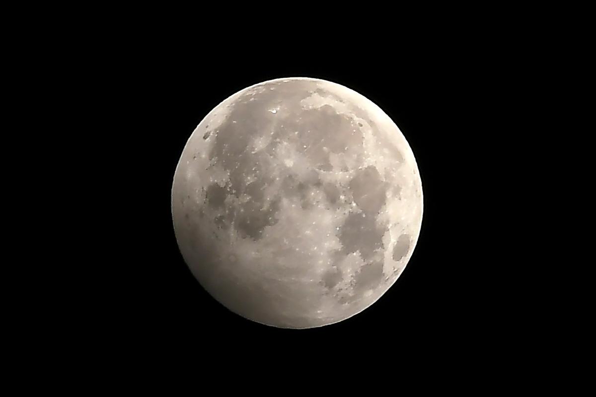 The full moon during the penumbral lunar eclipse is seen in Kathmandu on Jan. 11, 2020. (PRAKASH MATHEMA/AFP via Getty Images)