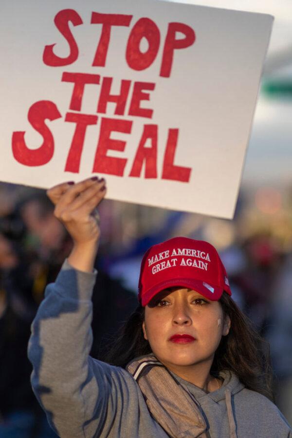 A woman holds a sign supporting the Stop the Steal movement, which raises concerns about the voting process in the 2020 presidential election, at a protest in Beverly Hills, Calif., on Nov. 7, 2020. (David McNew/AFP via Getty Images)