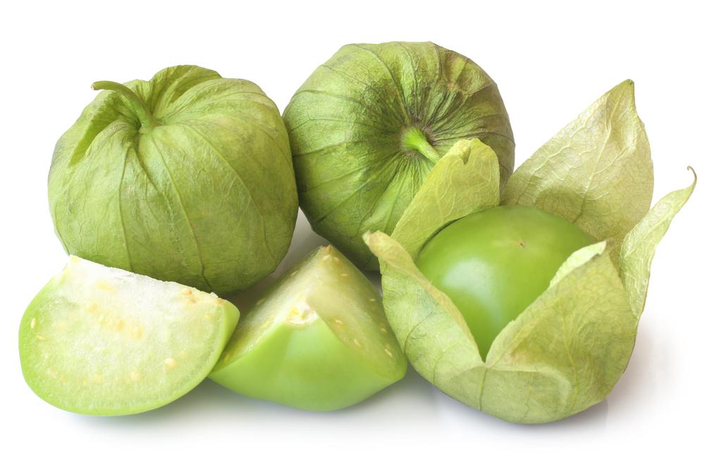 Tomatillos are wrapped in a papery husk, which, when removed, reveals a crab apple-sized green fruit that resembles a tomato. (Olga Popova/Shutterstock)