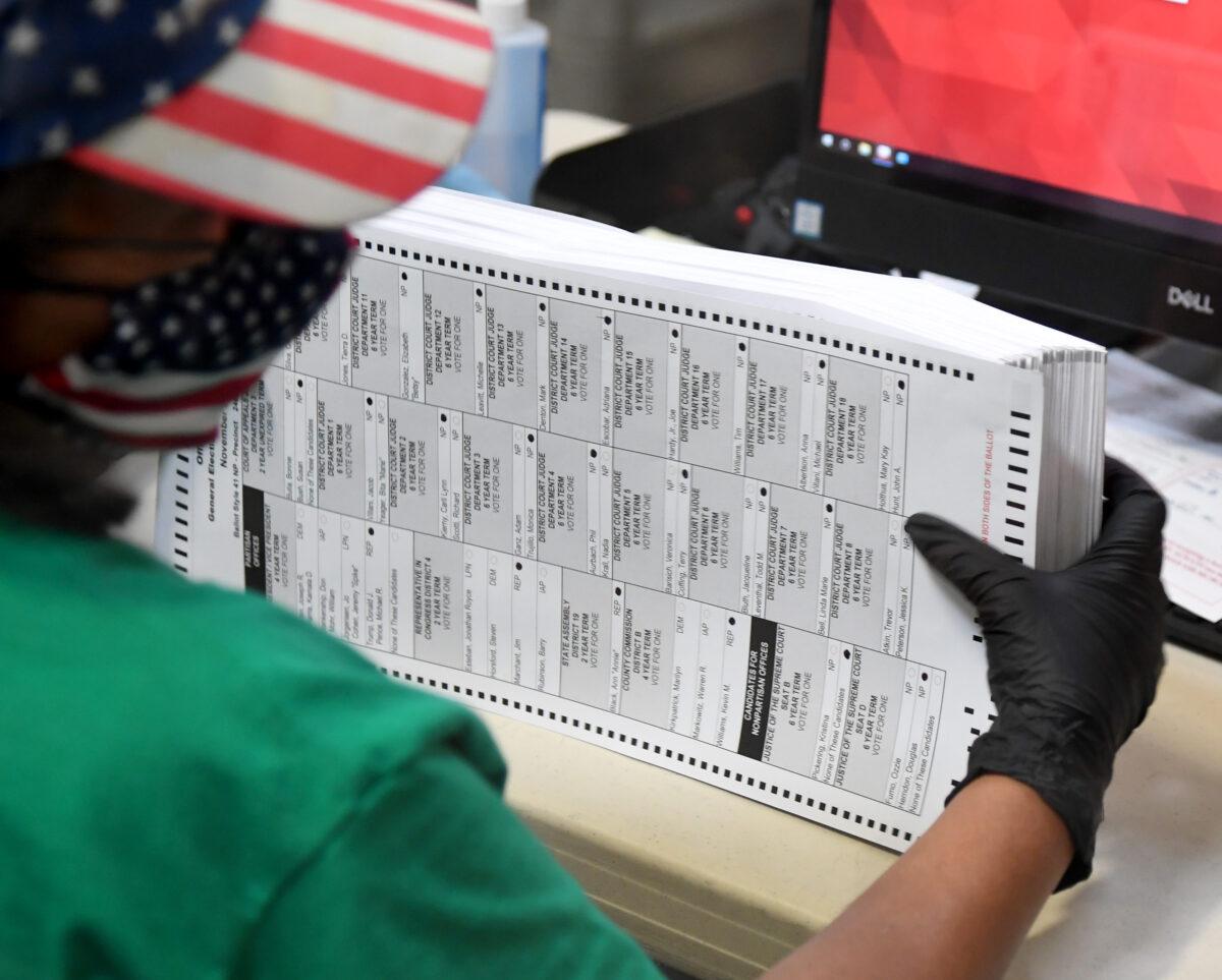 A Clark County election worker scans mail-in ballots at the Clark County Election Department in North Las Vegas, Nev., on Nov. 7, 2020. (Ethan Miller/Getty Images)