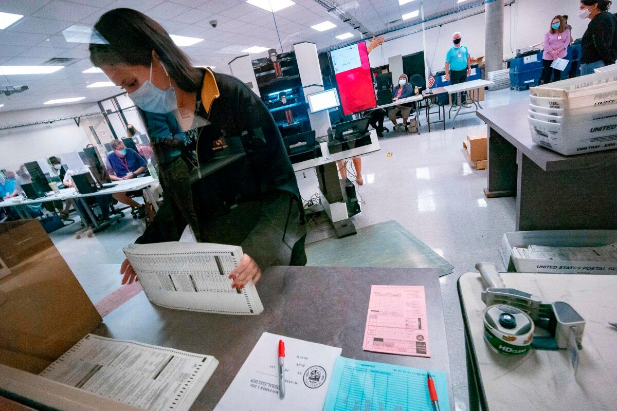 A poll worker sorts ballots inside the Maricopa County Election Department in Phoenix, Arizona on Nov. 5, 2020. (Olivier Touron/AFP via Getty Images)