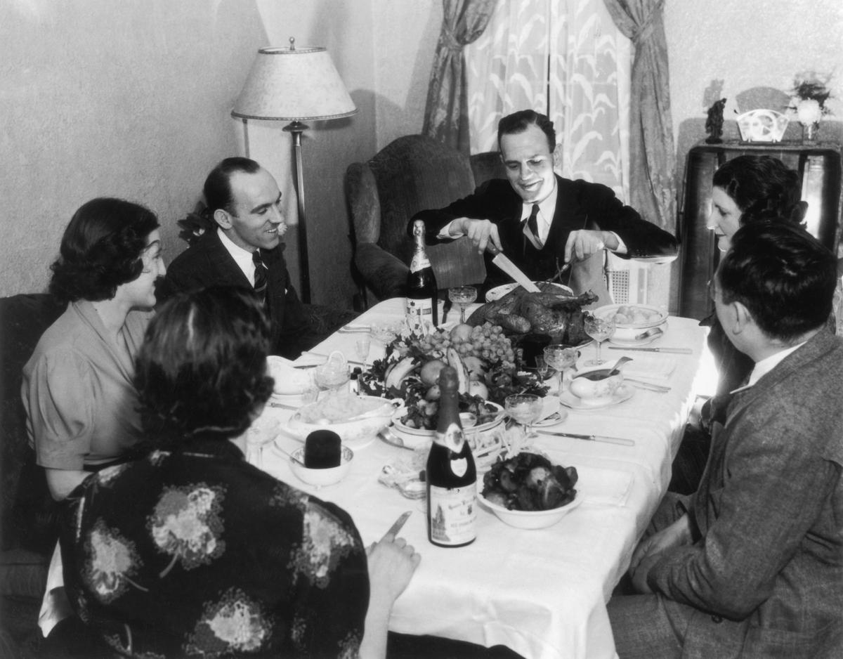 A family sit down to Thanksgiving dinner, circa 1935. (FPG/Hulton Archive/Getty Images)