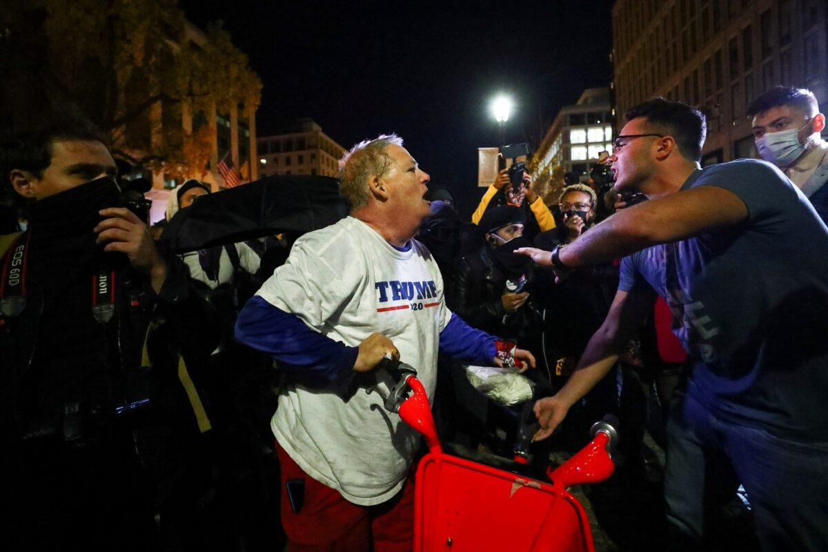A supporter of President Donald Trump is attacked by a group that chanted "Black Lives Matter," in Washington on Nov. 14, 2020. (Hannah McKay/Reuters)