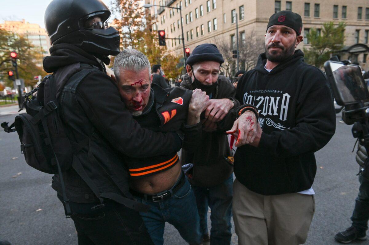The victim in an assault by a group including at least one Black Lives Matter activist is helped in Black Lives Matter Plaza in Washington on Nov. 14, 2020. (Roberto Schmidt/AFP via Getty Images)
