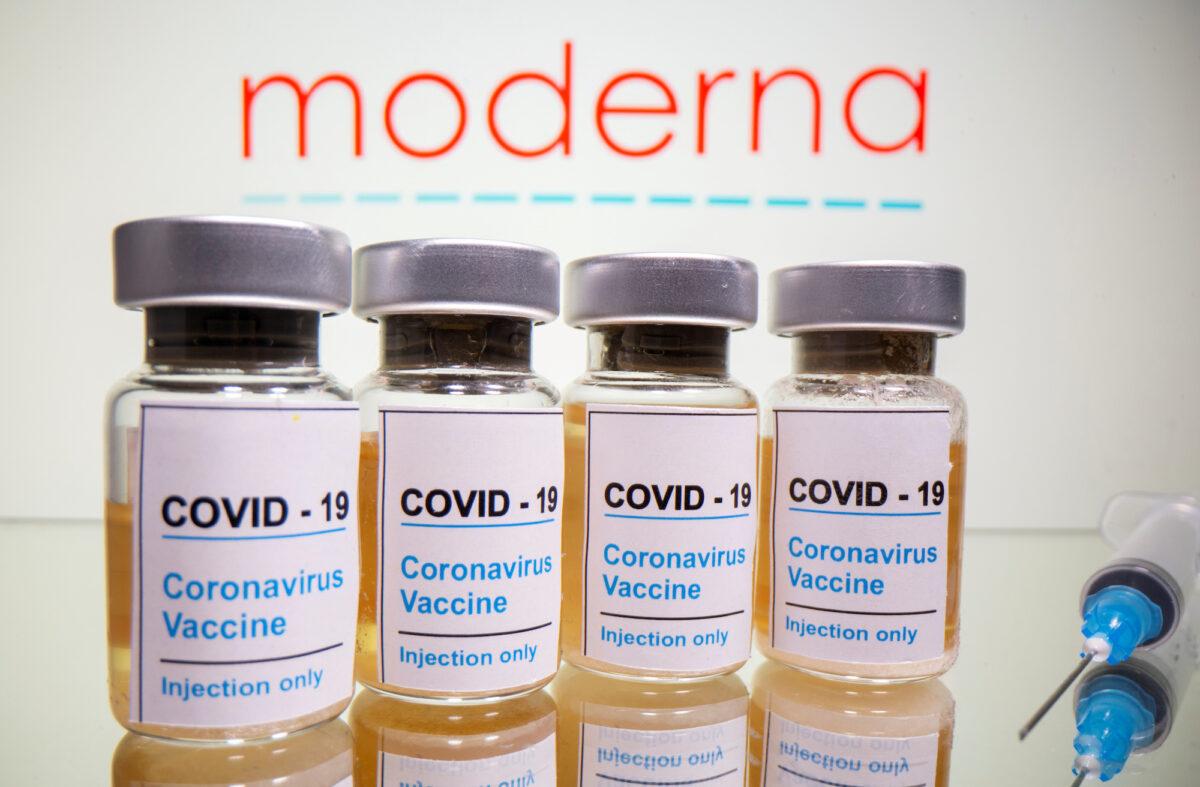 Vials with a sticker reading "COVID-19/Coronavirus vaccine/Injection only" and a syringe are seen in front of a displayed Moderna logo in this illustration taken Oct. 31, 2020. (Dado Ruvic/Illustration/File Photo/Reuters)