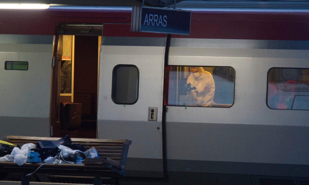 A police officer videos the crime scene inside a Thalys train after a gunman opened fire with an automatic weapon, at Arras train station, northern France, on Aug.21, 2015. (AP Photo)