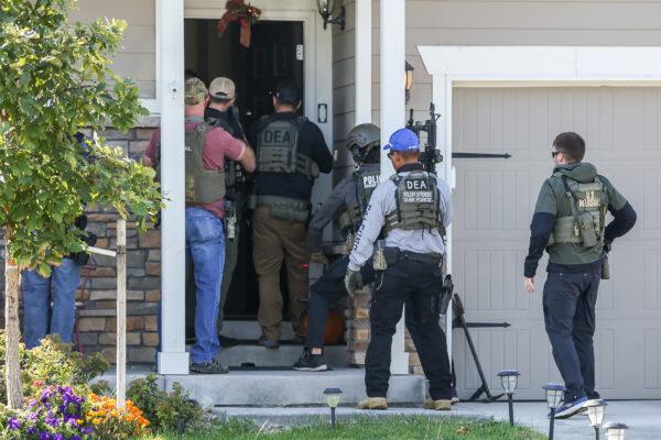 Drug Enforcement Administration agents and other law enforcement officers bust an illegal marijuana grow operation in a residential suburb in Denver, Colo., on Oct. 1, 2020. (Charlotte Cuthbertson/The Epoch Times)