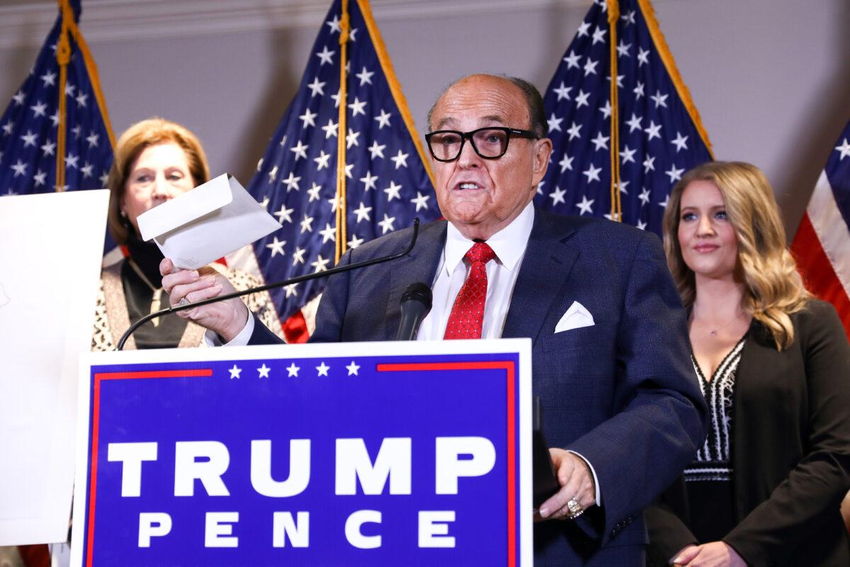 Trump lawyer and former New York City Mayor Rudy Giuliani speaks to media while flanked by lawyer Sidney Powell (L) and Trump campaign senior legal adviser Jenna Ellis at a press conference at the Republican National Committee headquarters in Washington, on Nov. 19, 2020. (Charlotte Cuthbertson/The Epoch Times)