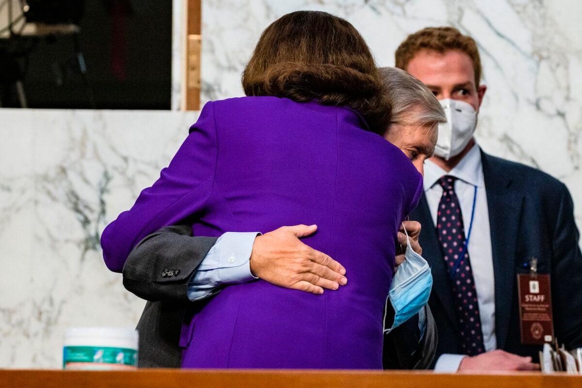 Ranking Member Diane Feinstein (D-Calif.) and Chairman Lindsey Graham (R-S.C.) hug as the confirmation hearings for Supreme Court nominee Judge Amy Coney Barrett come to a close on Capitol Hill in Washington, on Oct. 15, 2020. (Samuel Corum/Pool/AFP via Getty Images)
