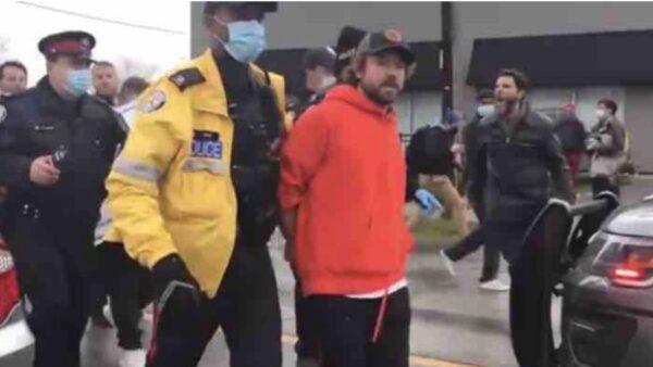 Adam Skelly, the owner of Ontario’s Adamson BBQ in Etobicoke, being taken away after allegedly defying lockdown orders. (GoFundMe)