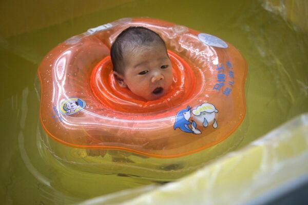 A baby swims in a bath at a private maternity hospital in Wuhan, central China’s Hubei Province on March 12, 2020. (Getty Images)