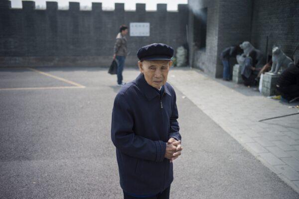 A man prays on the eve of the annual "Qingming" festival, or Tomb Sweeping Day, at a cemetary in Dagantangcun, 30km east of Beijing, China on April 4, 2015. (Fred Dufour/AFP via Getty Images)