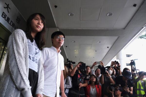 Pro-democracy activists Joshua Wong and Agnes Chow leave the Eastern Court after being released on bail over charged with unauthorised assembly near the police headquarters during anti-government protests in Hong Kong, on Aug. 30, 2019. (Tyrone Siu/Reuters)