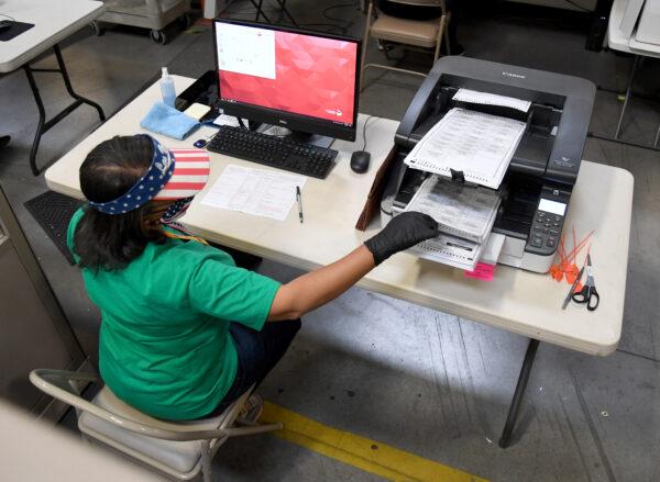 A Clark County election worker scans mail-in ballots at the Clark County Election Department in North Las Vegas, Nevada, on Nov. 7, 2020. (Ethan Miller/Getty Images)