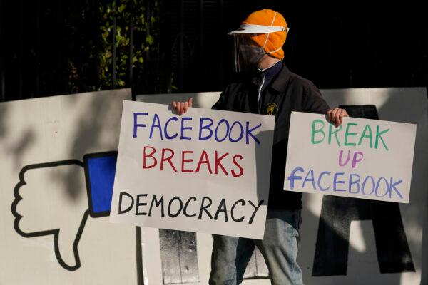A demonstrator joins others outside of the home of Facebook CEO Mark Zuckerberg to protest what they say is Facebook spreading disinformation in San Francisco on Nov. 21, 2020. (Jeff Chiu, AP Photo, File)
