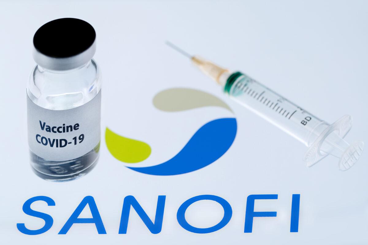 This picture shows a bottle reading "Vaccine Covid-19" next to French biopharmaceutical company Sanofi logo on Nov. 23, 2020. (Joel Saget/AFP via Getty Images)