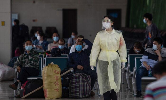 A staff member wearing a face shield walks through a bus station in Wuhan in central China's Hubei province on April 30, 2020. (STR/AFP via Getty Images)