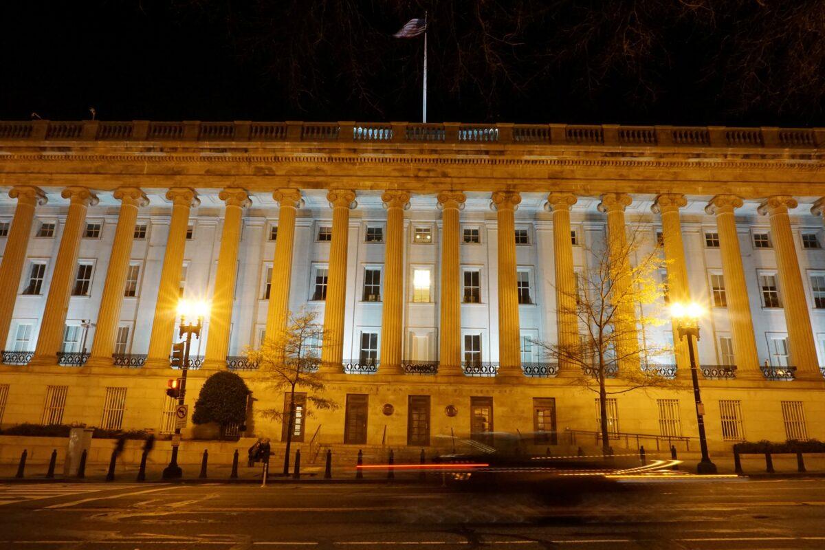 A vehicle drives past the U.S. Treasury Department in Washington on Dec. 13, 2020. (Raphael Satter/Reuters)
