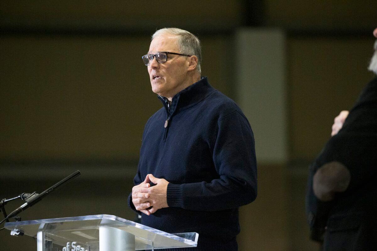 Washington Gov. Jay Inslee and other leaders speak to the press in Seattle, Wash., on March 28, 2020. (Karen Ducey/Getty Images)