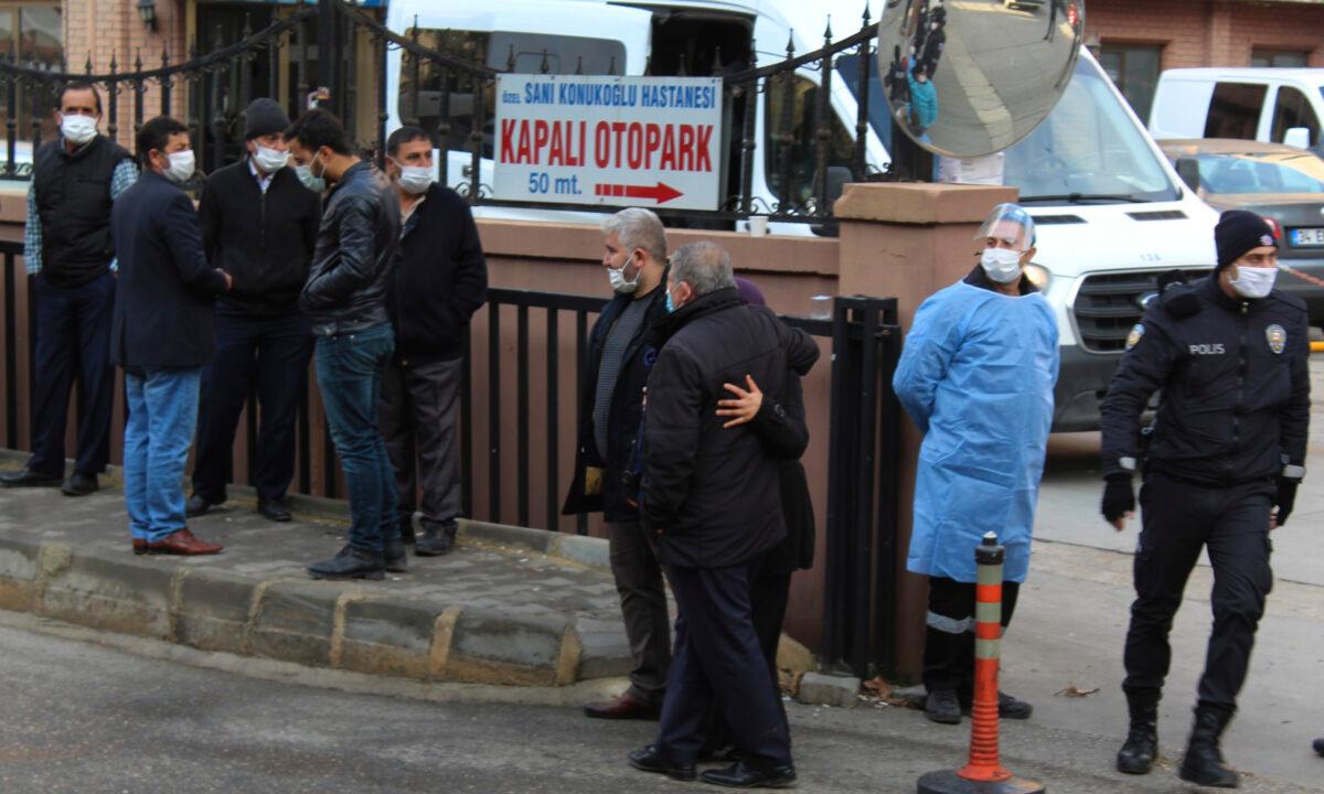 People, police, and medics gather outside the privately-run Sanko University Hospital in Gaziantep, Turkey, on Dec. 19, 2020. (IHA via AP)
