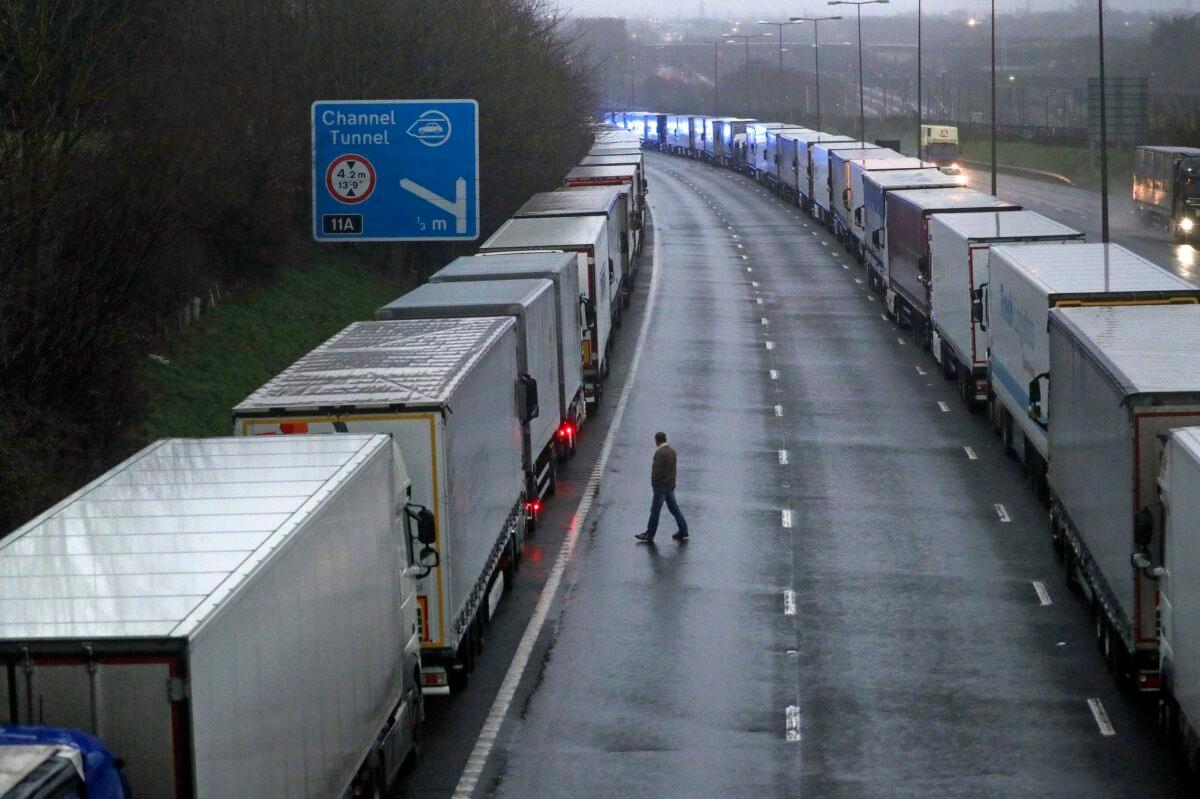 Lorries are parked on the M20 as part of Operation Stack after the Port of Dover was closed and access to the Eurotunnel terminal suspended following the French government's announcement, near Folkestone, Kent, England, on Dec. 21, 2020. (Steve Parsons/PA via AP)