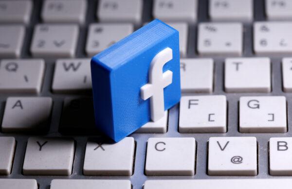A 3D-printed Facebook logo is seen placed on a keyboard in this illustration taken March 25, 2020. (Dado Ruvic/Illustration)