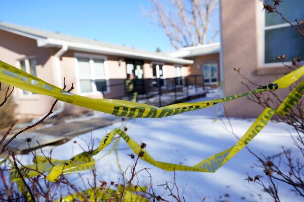 Caution tape hangs in the shrubs in front of the Good Samaritan Society care center, which is closed to the public, in Simla, Colorado, on Dec. 30, 2020. (AP Photo/David Zalubowski)