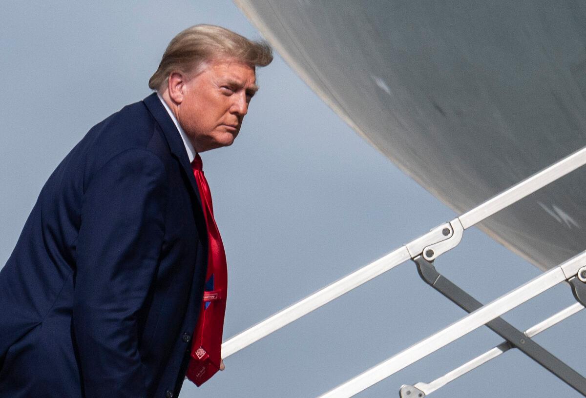 President Donald Trump boards Air Force One while departing from Palm Beach International Airport in West Palm Beach, Fla., on Dec. 31, 2020. (Andrew Caballero-Reynolds/AFP via Getty Images)