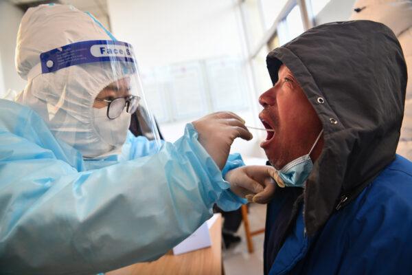 Medical workers are taking swab samples from residents in Shijiazhuang, in northern China's Hebei Province on Jan. 6, 2021. (STR/CNS/AFP via Getty Images)