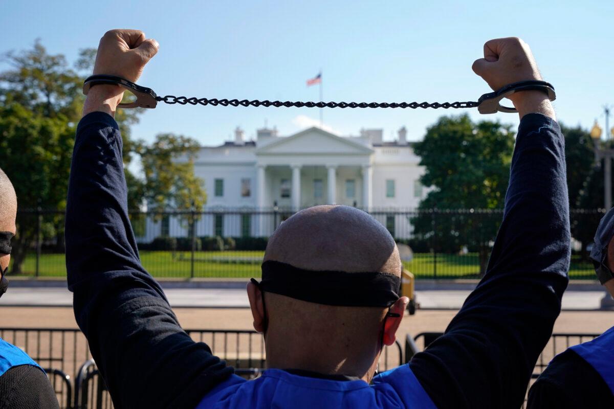 A member of the Uyghur American Association rallies in front of the White House after marching from Capitol Hill in Washington, in support of the Uyghur Forced Labor Prevention Act which has passed the House and now will go on to the Senate, in Washington on Oct. 1, 2020. (Jacquelyn Martin/AP Photo)