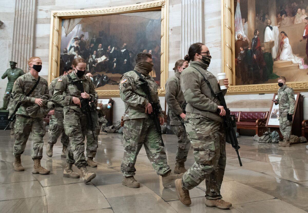 Members of the National Guard walk through the Rotunda of the US Capitol in Washington on Jan. 13, 2021. (Saul Loeb/AFP via Getty Images)