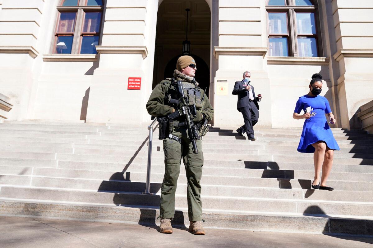 A Georgia State Patrol S.W.A.T. team member stands guard outside the Georgia State Capitol building in Atlanta, Ga. on Jan. 14, 2021. (John Bazemore/AP Photo)