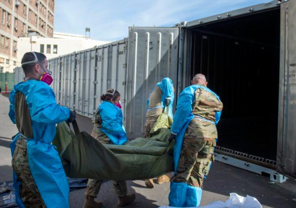 National Guard members assist with the transfer of COVID-19 fatalities into temporary storage in Los Angeles on Jan. 12, 2021. (Los Angeles County Department of Medical Examiner-Coroner via AP, File)