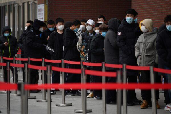 People line up outside a hospital to get COVID-19 tests in Beijing, on Jan. 14, 2021. (Greg Baker/AFP via Getty Images)