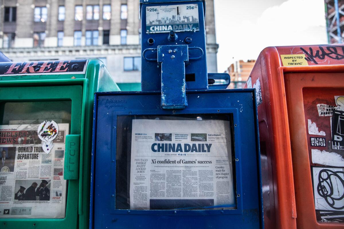 A China Daily newspaper box is with other free daily papers in New York on Jan. 20, 2021. (Chung I Ho/The Epoch Times)