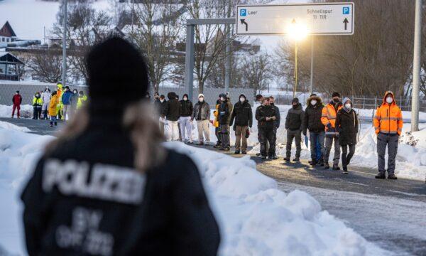 People wait in front of a coronavirus test station at the German-Czech Republic border in Furth im Wald, Germany, on Jan. 25, 2021. (Armin Weigel/dpa via AP)