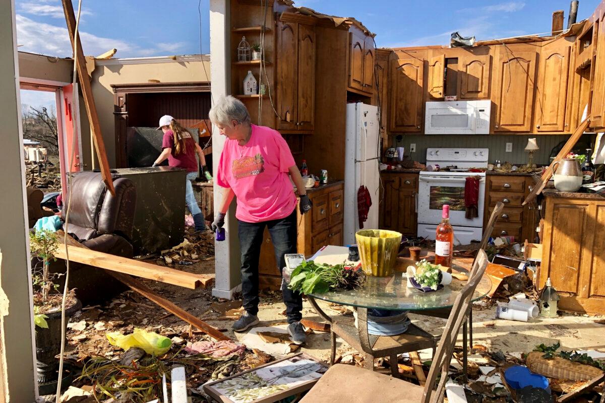 Patti Herring sobs as she sorts through the remains of her home in Fultondale, Ala., on Jan. 26, 2021, after it was destroyed by a tornado. (Jay Reeves/AP Photo)