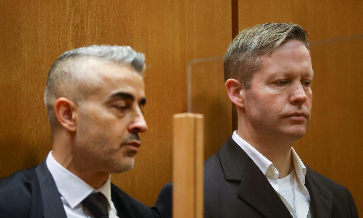 Main defendant Stephan Ernst, right, and his lawyer Mustafa Kaplan, left, look on in the courtroom as they wait for the verdict in the case of the murder of Walter Luebcke, at the Higher Regional Court in Frankfurt, Germany, on Jan. 28, 2021. (Kai Pfaffenbach/Pool/Reuters)