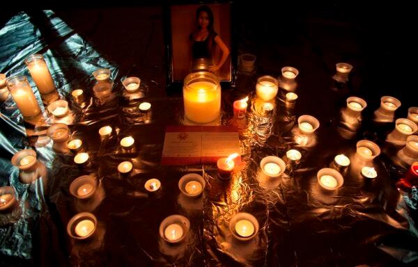 Candles are seen in front of a picture of Amanda Todd during a memorial for her in Surrey, B.C., on Oct. 19, 2012. (The Canadian Press/Jonathan Hayward)