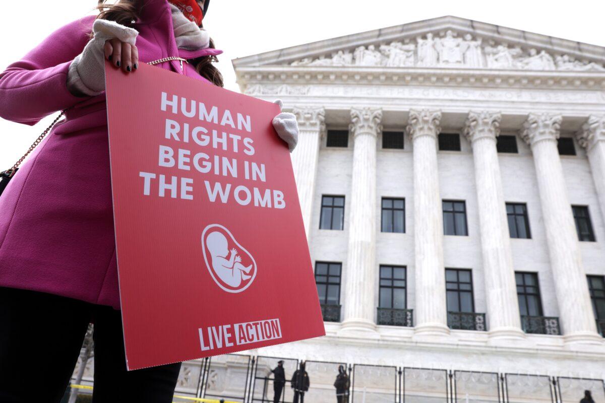A pro-life activist holds a sign outside the U.S. Supreme Court during the 48th annual March for Life in Washington on Jan. 29, 2021. (Alex Wong/Getty Images)