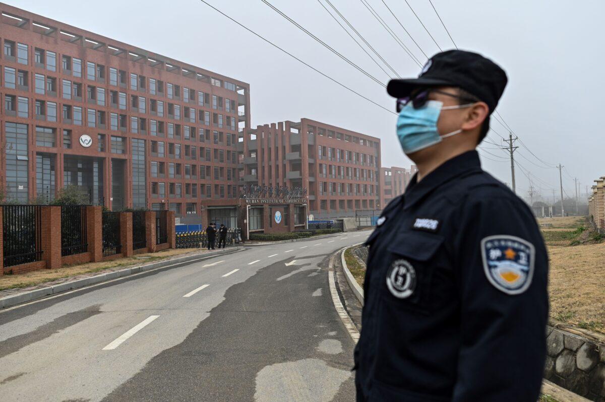 A security personnel stands guard as members of the World Health Organization (WHO) team investigating the origins of the COVID-19, make a visit to the Wuhan Institute of Virology in Wuhan, in China's central Hubei Province on Feb. 3, 2021. (Hector Retamal/AFP via Getty Images)