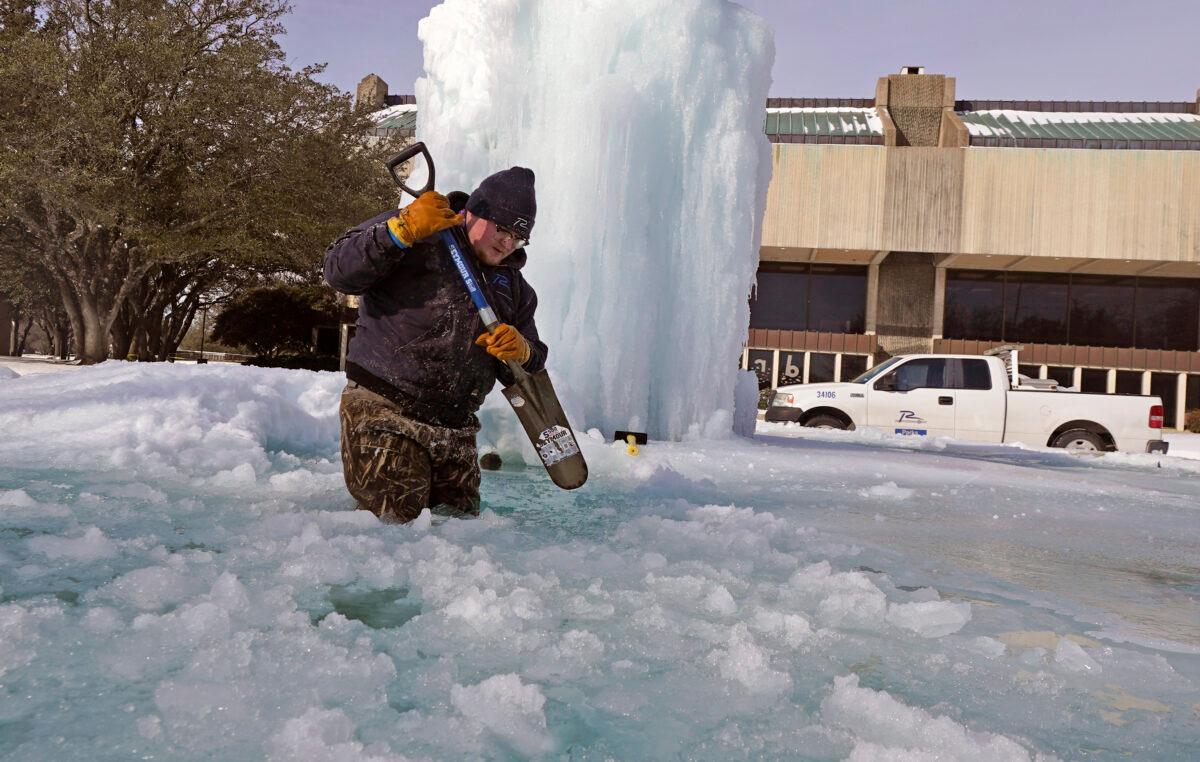 City of Richardson worker Kaleb Love breaks ice on a frozen fountain in Richardson, Texas, on Feb. 16, 2021. (LM Otero/AP Photo)