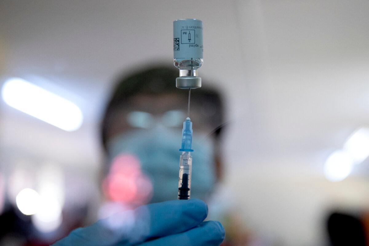 A healthcare worker fills a syringe from a vial with a dose of the Johnson & Johnson vaccine against COVID-19 at a hospital in South Africa on Feb. 18, 2021. (Phill Magakoe/AFP via Getty Images)