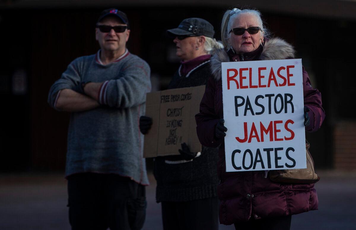 Supporters gather outside court as Pastor James Coates of GraceLife Church is in court after he was arrested last week for holding Sunday services in violation of COVID-19 rules, in Stony Plain, Canada, on Feb. 24, 2021. (Jason Franson/The Canadian Press)