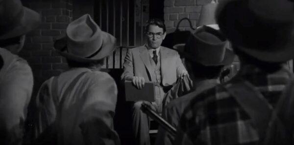 Atticus Finch (Gregory Peck) standing against a mob. (Universal Pictures)