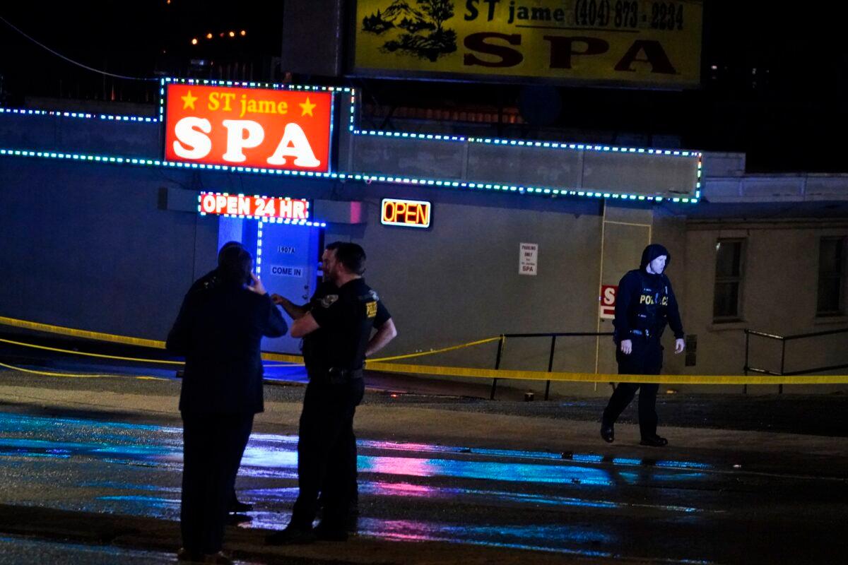 Law enforcement officials confer outside a massage parlor following a shooting in Atlanta, Ga., on March 16, 2021. (Brynn Anderson/AP Photo)