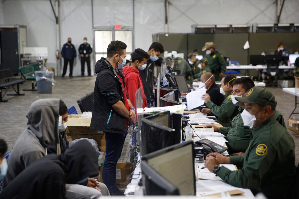 Illegal immigrants reprocessed at the intake area of the Donna Department of Homeland Security holding facility, the main detention center for unaccompanied minors in the Rio Grande Valley, in Donna, Texas, on March 30, 2021. (Dario Lopez-Mills/Pool)